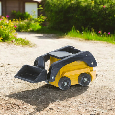 Yellow Wooden Toy Skid Loader in the yard