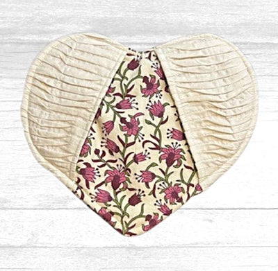 Pretty and practical!  This heart Shaped Potholder with pockets is cream colored on the outside and has a pretty pink flower pattern on the back and where the pockets are. 