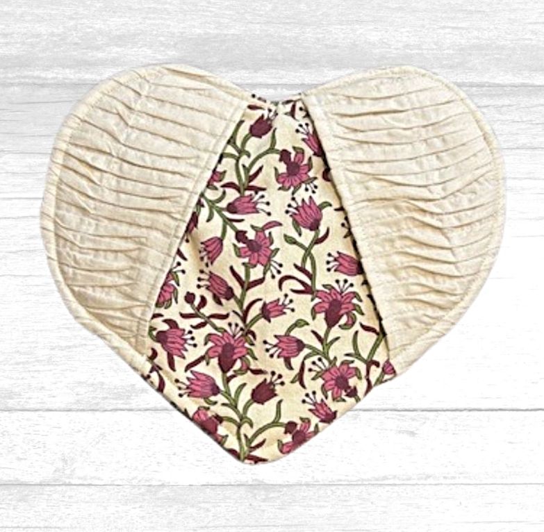 Pretty and practical!  This heart Shaped Potholder with pockets is cream colored on the outside and has a pretty pink flower pattern on the back and where the pockets are. 