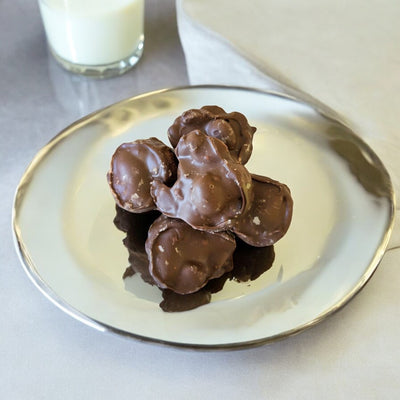 Chocolate Peanut Clusters with a glass of milk