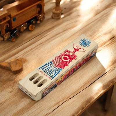 Three-Note Wooden Train Whistle On A Table By a Toy Train Set