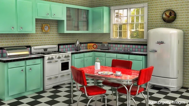 1950s Kitchen with mint green cabinets, checkered floor and red table with red vinyl chairs