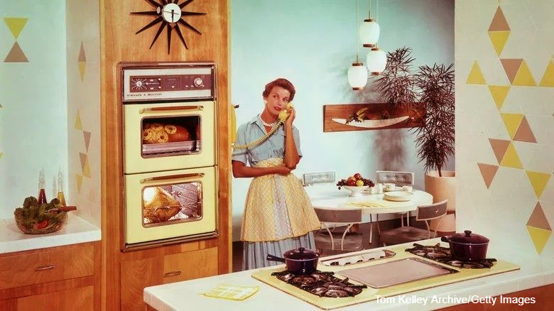 1950's Kitchen with Woman on the phone attached to the wall