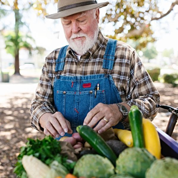 A farmer at a market selling his harvest.