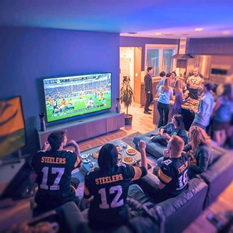 At home watching the Super Bowl on TV with friends